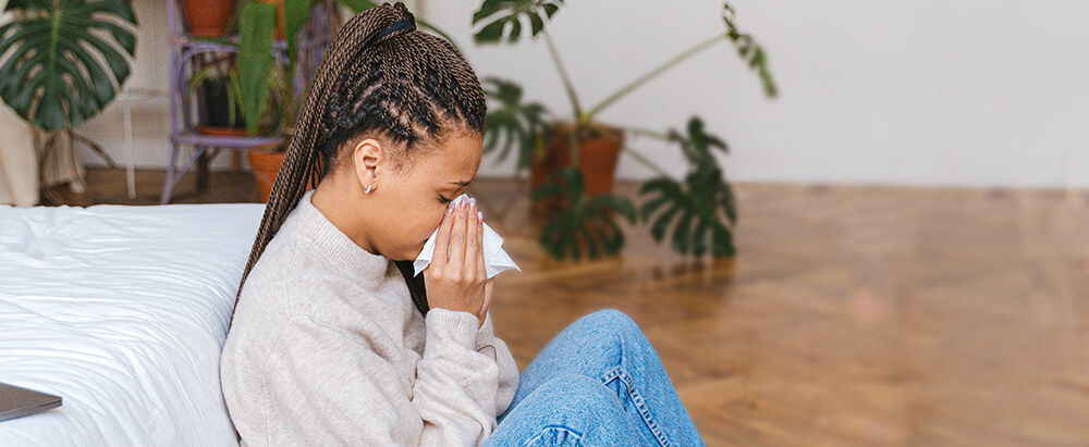 Woman sneezing with allergies