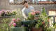 Man planting flowers on rooftop garden