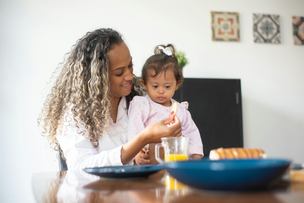 Woman feeding young child