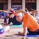 Class of people doing yoga poses on exercise mats