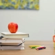 School supplies of apple, books, pencils and blocks sitting on desk