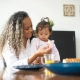 Mother feeding young child