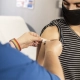 Doctor putting band-aid on patient's arm