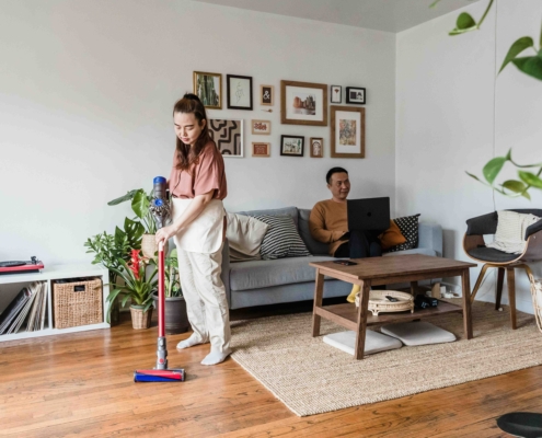 Woman vacuuming to remove dust mites and reduce allergy symptoms