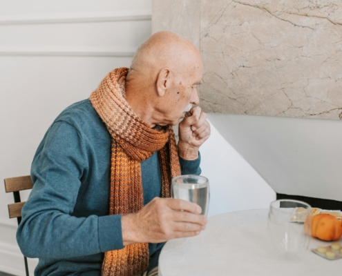 Elderly man in need of an allergy and asthma specialist appointment to treat his chronic cough.