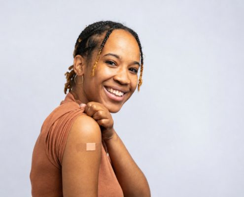 Woman smiling after receiving an allergy shot to treat her allergy symptoms